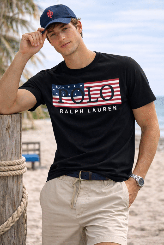 black Polo Ralph Lauren T-shirt with American flag logo standing on a beach.